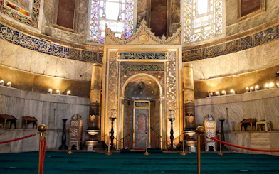 Interior of Hagia Sophia's mihrab, Istanbul, showcasing intricate Islamic calligraphy and architecture.