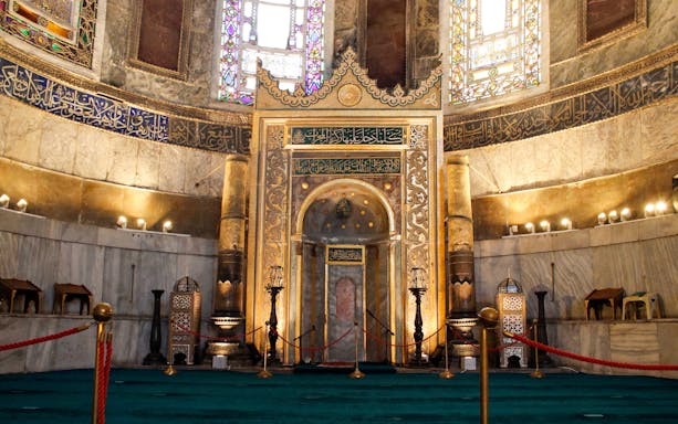 Interior of Hagia Sophia's mihrab, Istanbul, showcasing intricate Islamic calligraphy and architecture.