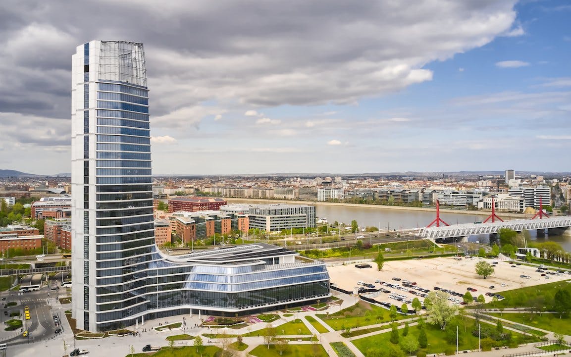 Budapest skyline featuring the MOL HQ skyscraper near the Danube River.