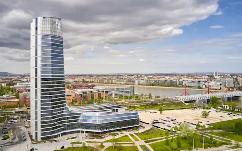 Budapest skyline featuring the MOL HQ skyscraper near the Danube River.
