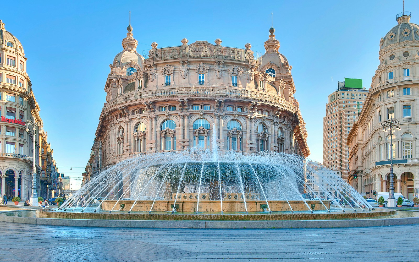 Fountain at Piazza De Ferrari in Genoa with historic buildings in the background.