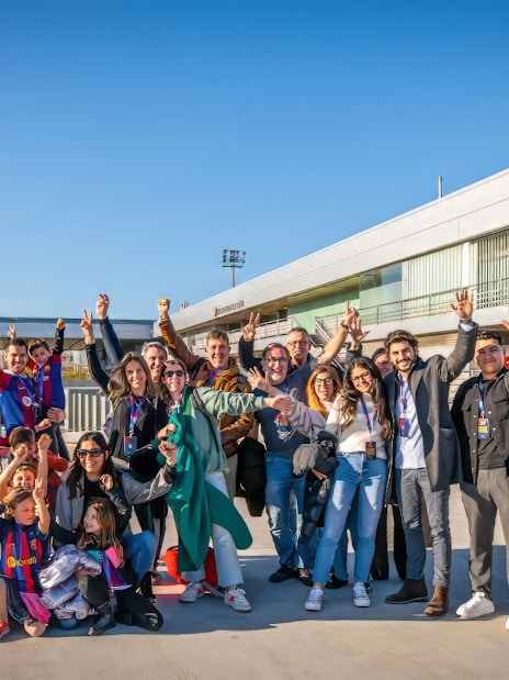Group of visitors enjoying the Players Experience tour at Barça Museum and J. Cruyff Stadium.