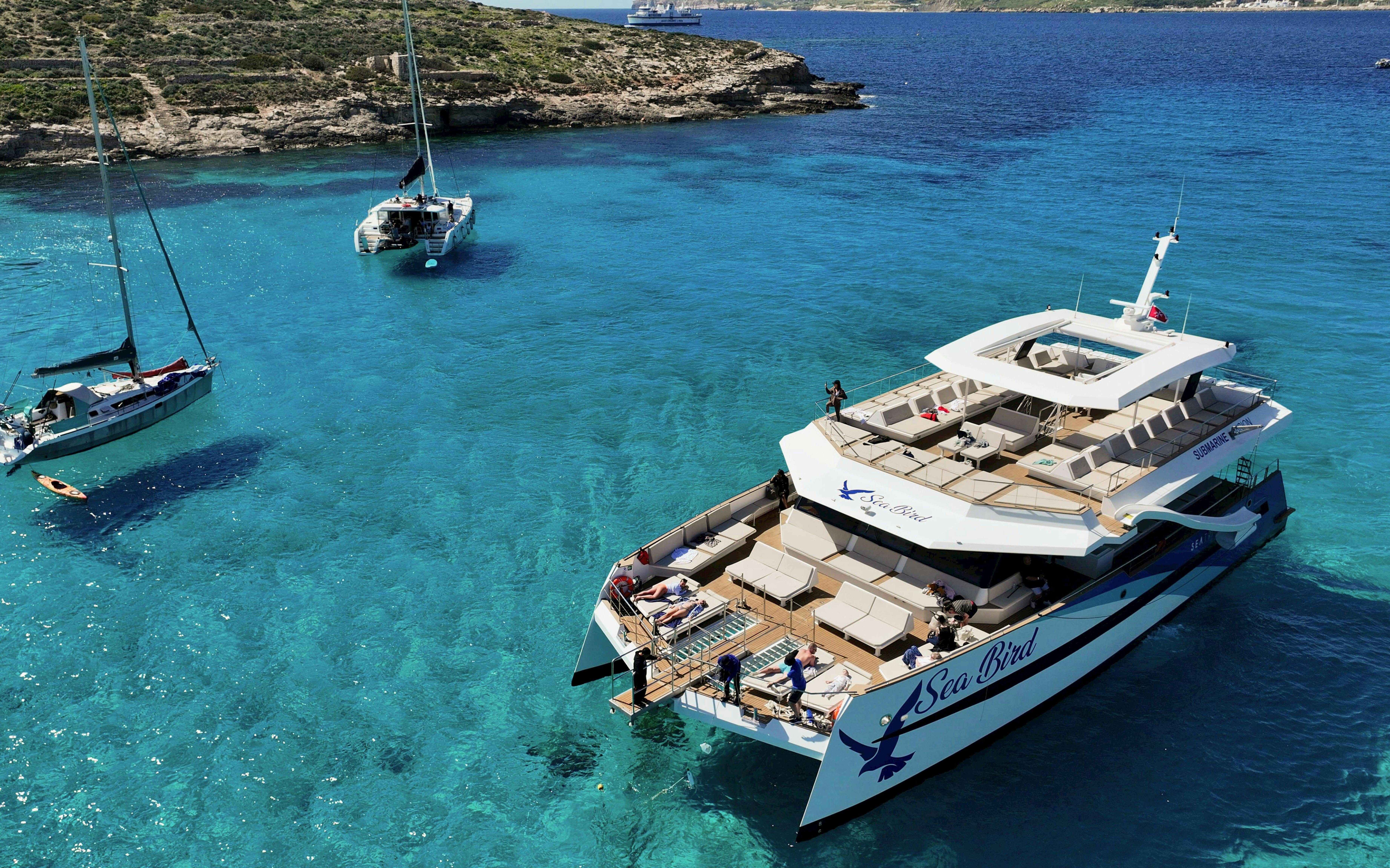 Tourist boat anchored in Blue Lagoon's clear waters during Full Day Blue Lagoon tour.