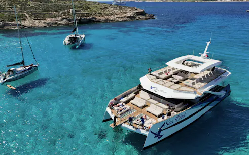 Tourist boat anchored in Blue Lagoon's clear waters during Full Day Blue Lagoon tour.