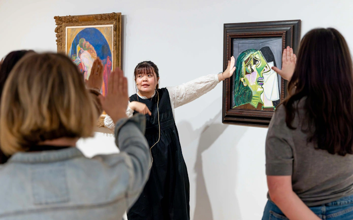 Tour guide explaining artwork at National Gallery of Victoria during Best of NGV Experiences Tour.