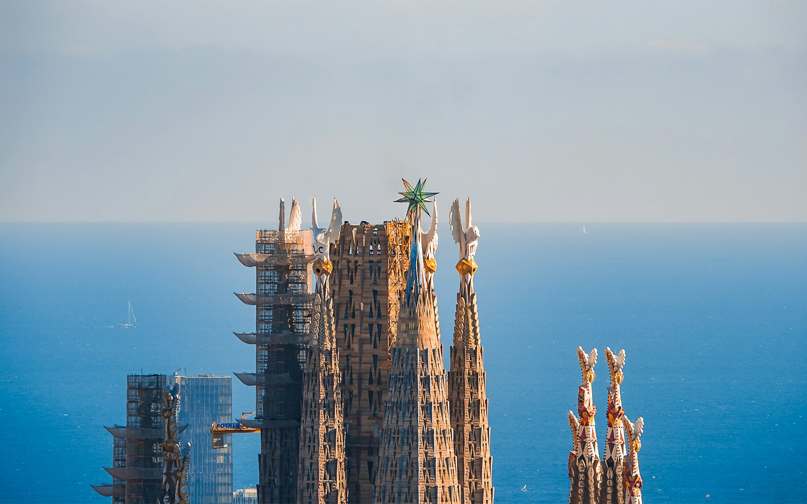 Sagrada Familia towers with intricate spires in Barcelona, view from guided tour access point.