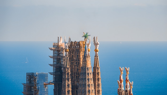 Sagrada Familia towers with intricate spires in Barcelona, view from guided tour access point.