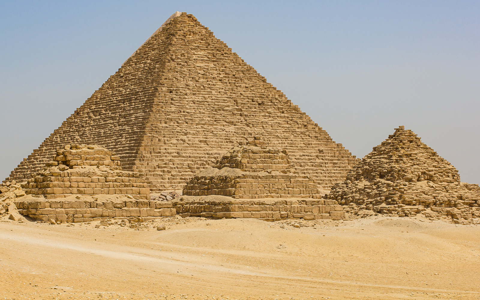 Great Pyramid of Khufu in Giza, Egypt, with smaller pyramids in the foreground.