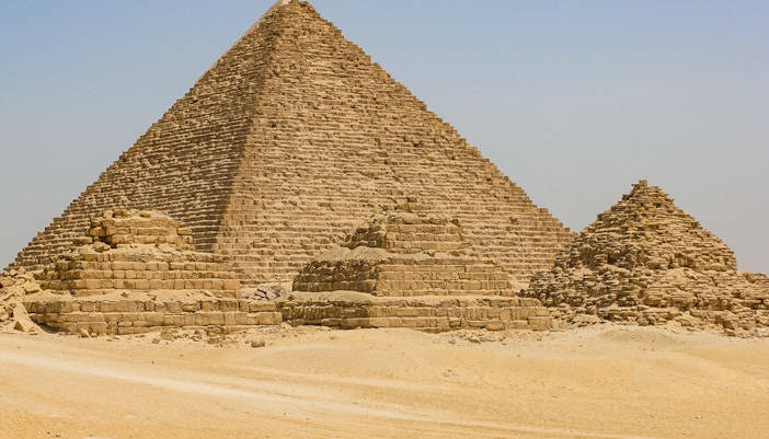 Great Pyramid of Khufu in Giza, Egypt, with smaller pyramids in the foreground.