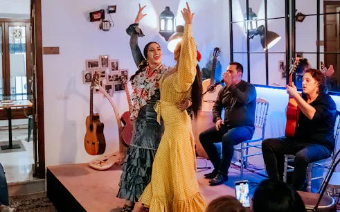 Flamenco dancers performing at Taberna Doble de Cepa with live guitar music.