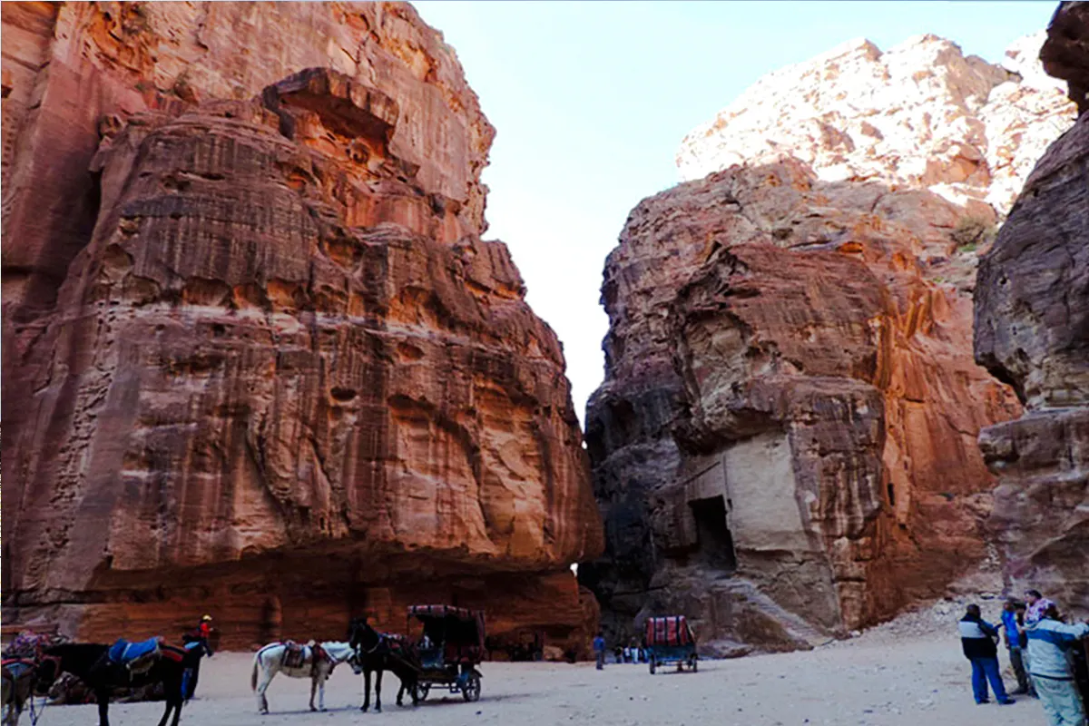 Horse-drawn carriages at the entrance of Little Petra, Jordan, during a guided tour from Amman.