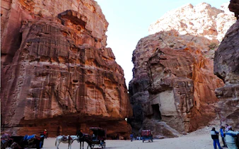 Horse-drawn carriages at the entrance of Little Petra, Jordan, during a guided tour from Amman.