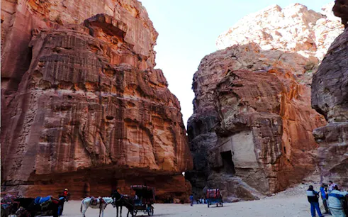 Horse-drawn carriages at the entrance of Little Petra, Jordan, during a guided tour from Amman.