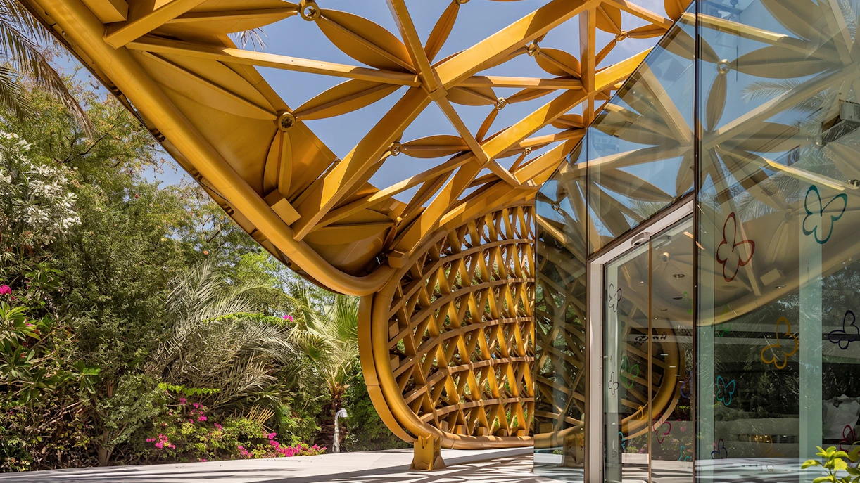 Al Noor Island Butterfly House entrance with intricate golden lattice design.