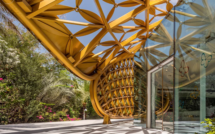 Al Noor Island Butterfly House entrance with intricate golden lattice design.
