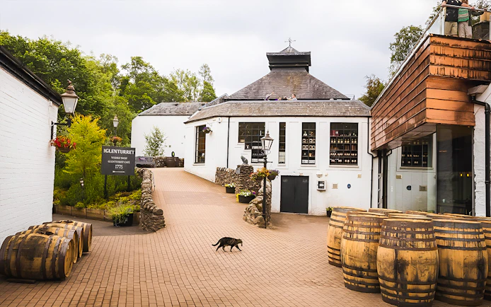 Glenturret Distillery courtyard with whisky barrels, part of Edinburgh day tour.
