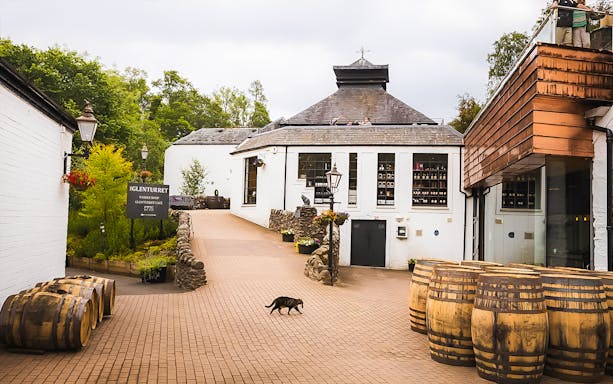 Glenturret Distillery courtyard with whisky barrels, part of Edinburgh day tour.