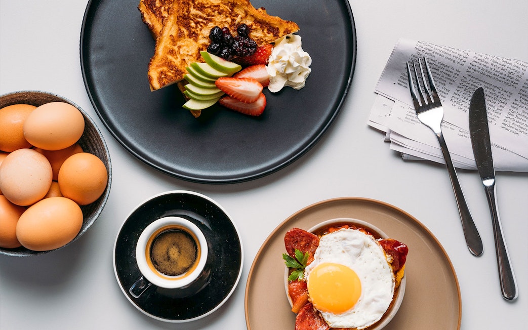 Breakfast spread with eggs, toast, fruit, and coffee at Plaza Premium Lounge, International Arrival.