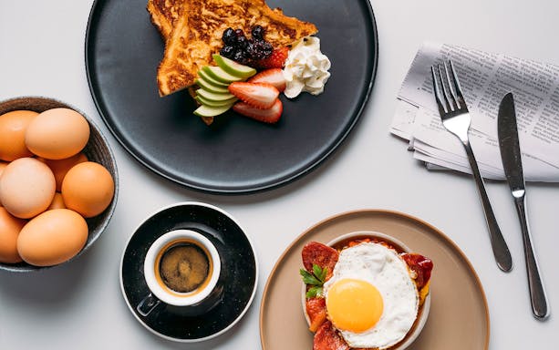Breakfast spread with eggs, toast, fruit, and coffee at Plaza Premium Lounge, International Arrival.