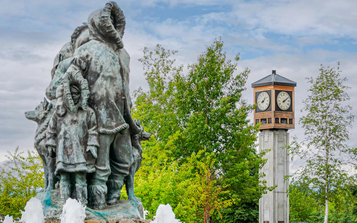 Statue of Unknown First Family with fountain at Golden Heart Plaza, Fairbanks, Alaska.