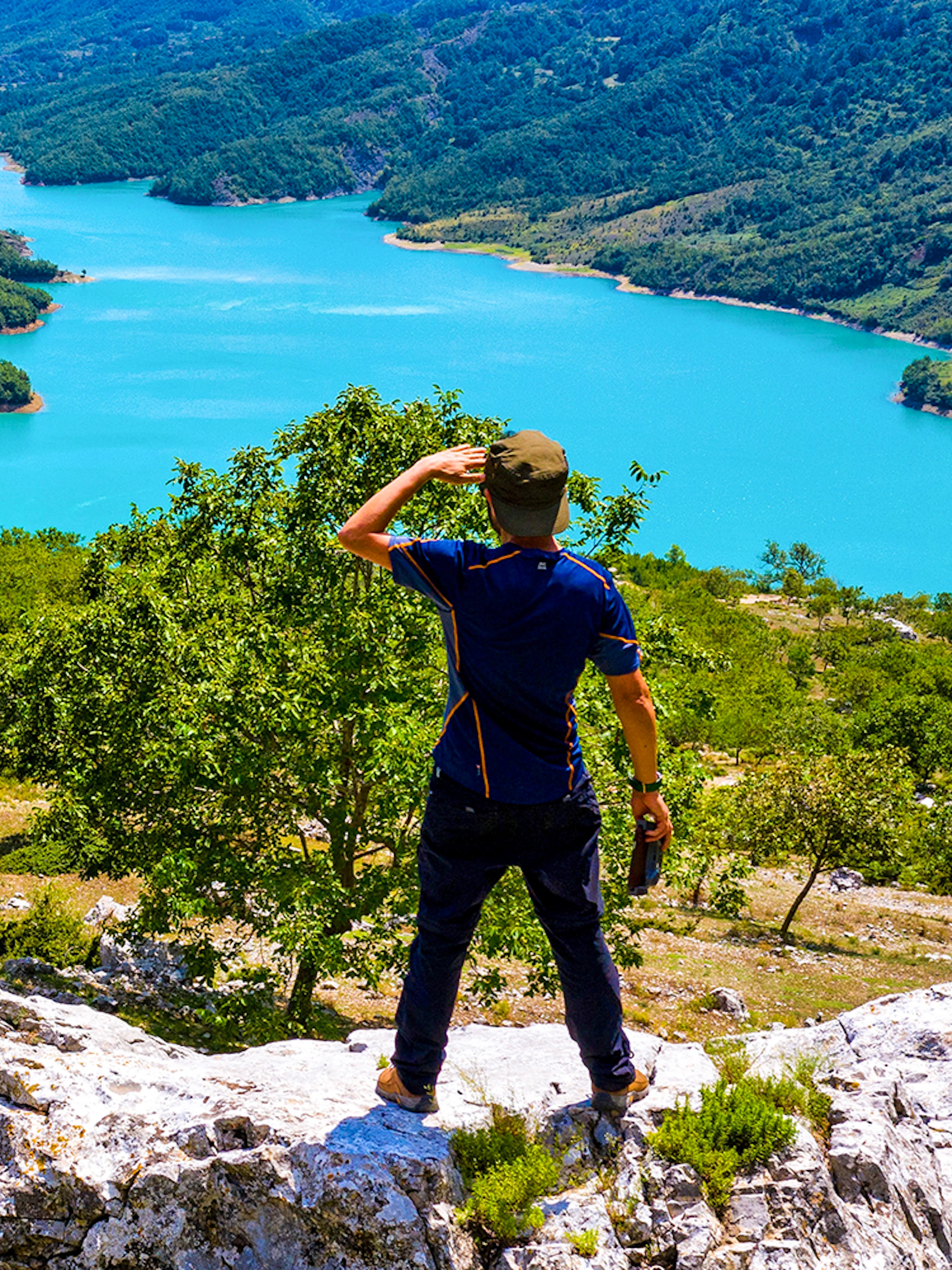 Male hiker on Gamti Mountain overlooking Bovilla Lake, Albania.