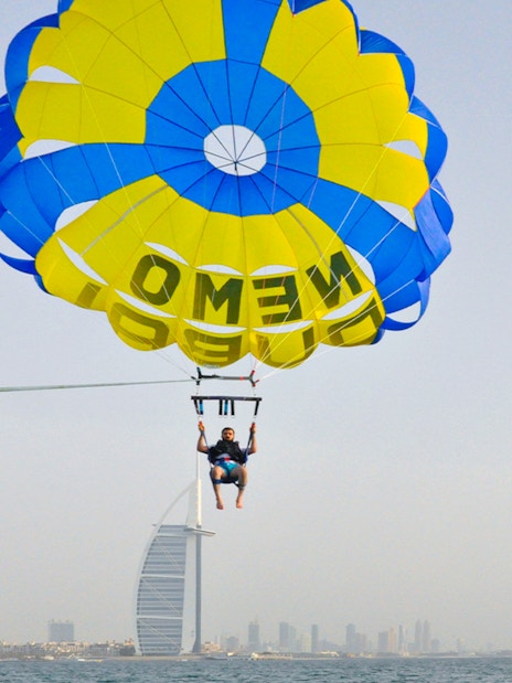 Parasailing over Dubai with Burj Al Arab in the background.