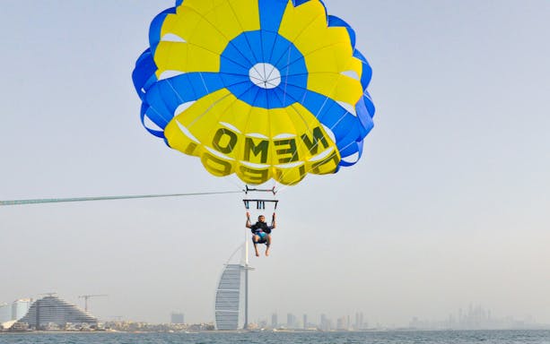 Parasailing over Dubai with Burj Al Arab in the background.
