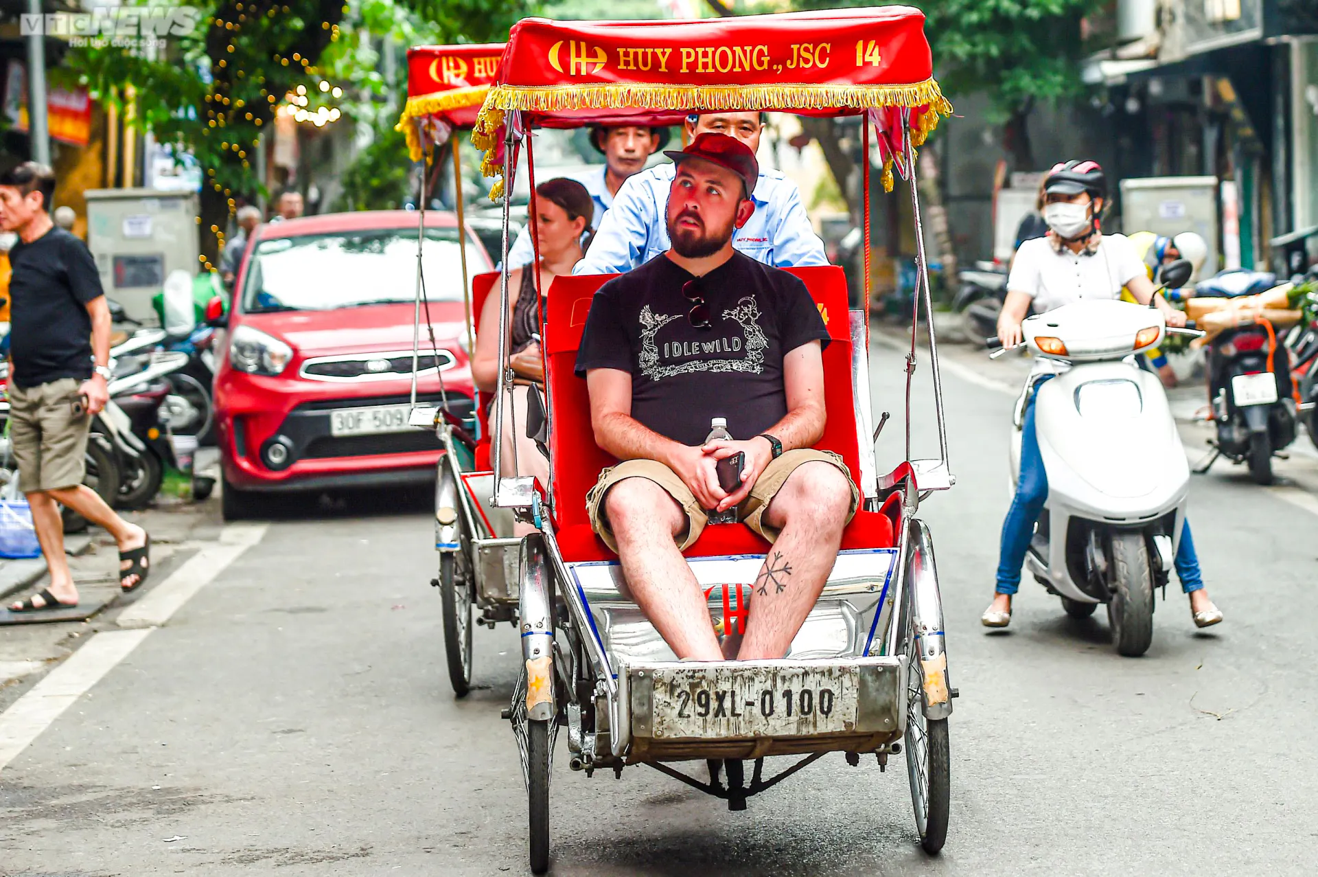 Cyclo ride through Hanoi street near Temple of Literature and Ho Chi Minh Complex.