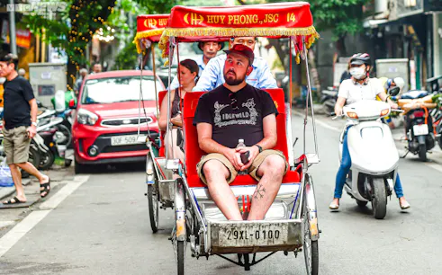 Cyclo ride through Hanoi street near Temple of Literature and Ho Chi Minh Complex.