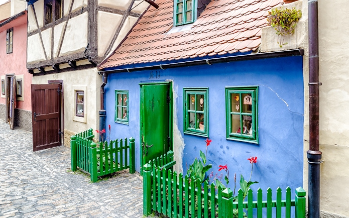 Blue house with green door and windows on Golden Lane, Prague.