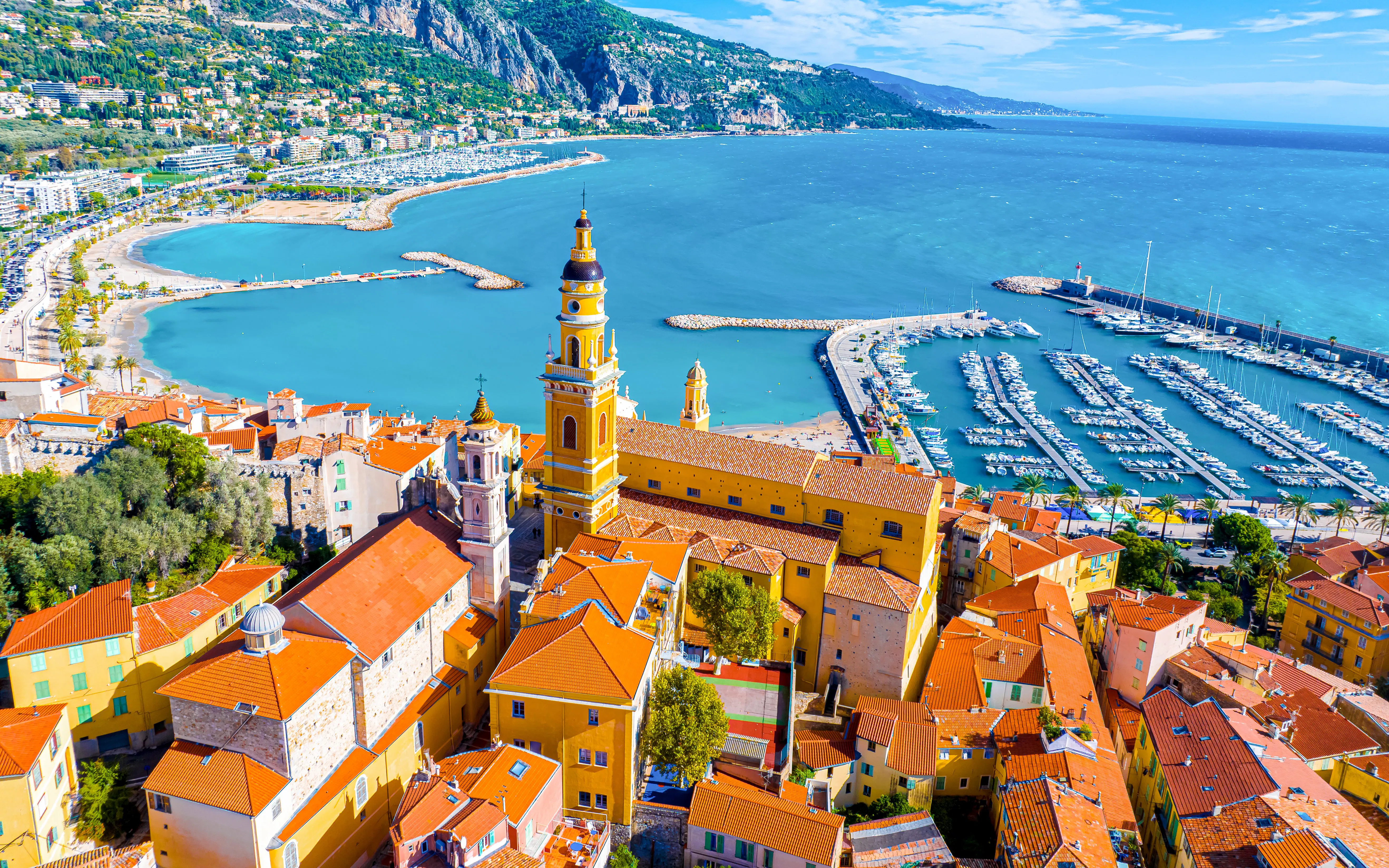 Aerial view of Menton with Saint-Michel Basilica and marina on the French Riviera.