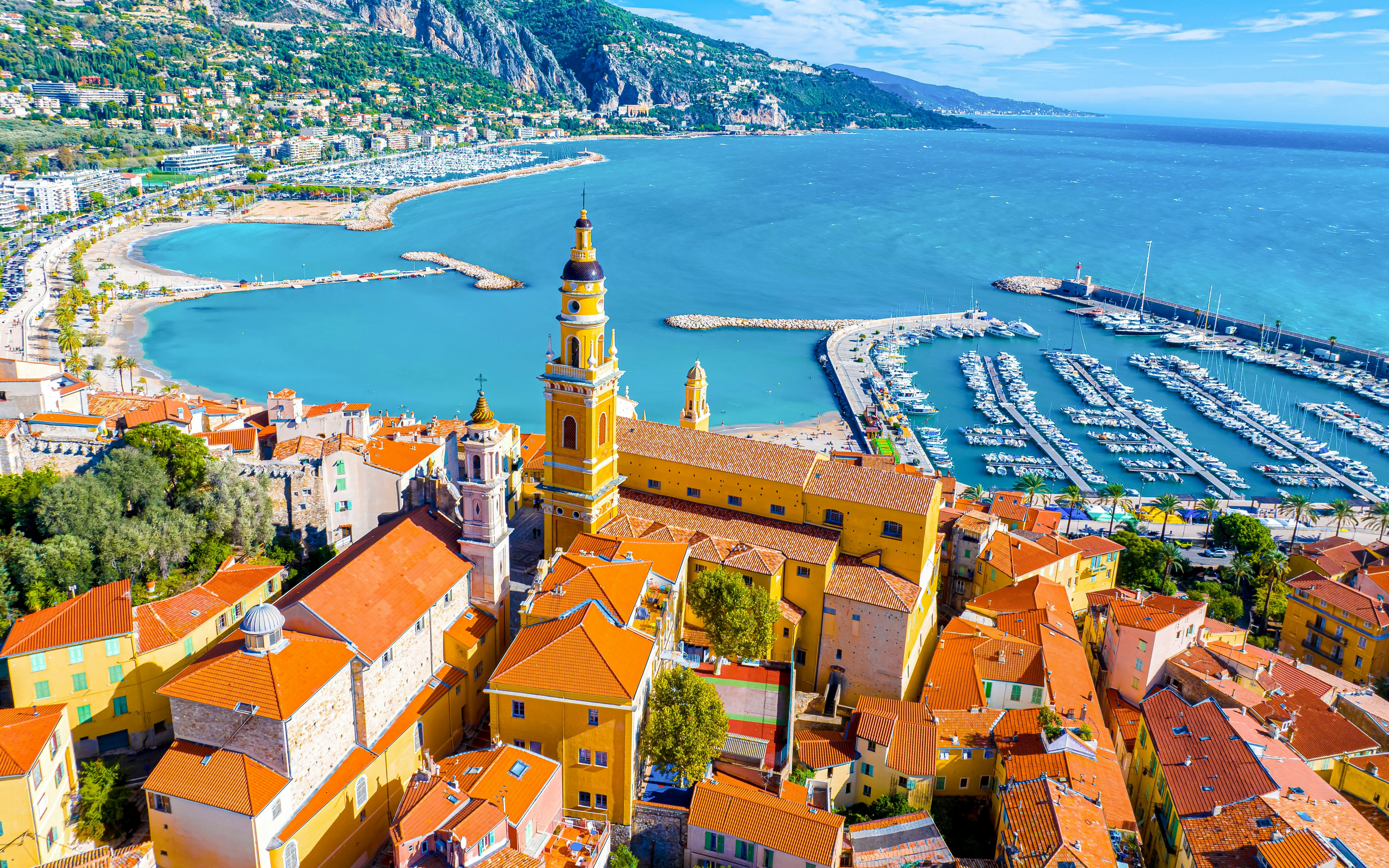 Aerial view of Menton with Saint-Michel Basilica and marina on the French Riviera.