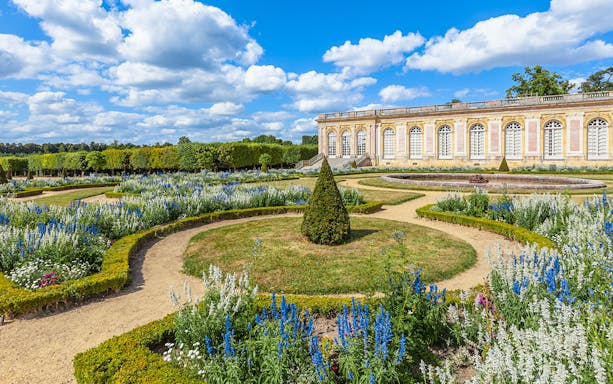 Garden paths and flowerbeds at the Grand Trianon Palace, Versailles, France.