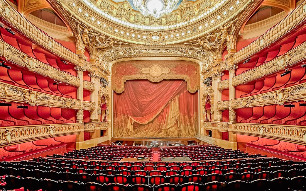 Auditorium of Opera Garnier with ornate red and gold decor, Paris.