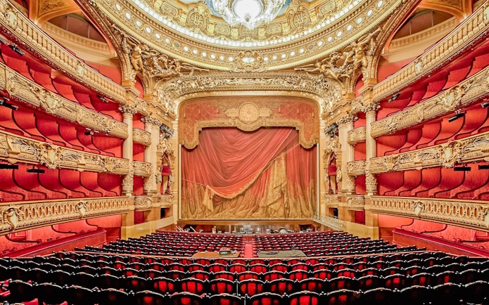 Auditorium of Opera Garnier with ornate red and gold decor, Paris.