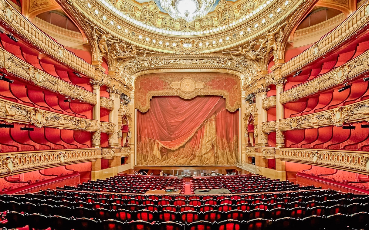 Auditorium of Opera Garnier with ornate red and gold decor, Paris.
