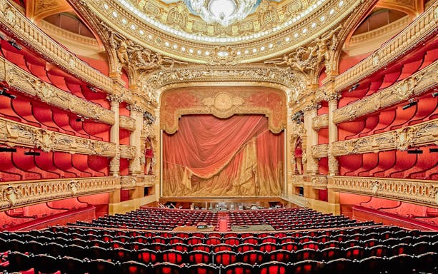 Auditorium of Opera Garnier with ornate red and gold decor, Paris.