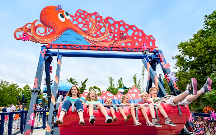 Visitors enjoying an octopus-themed ride at SeaWorld San Diego.