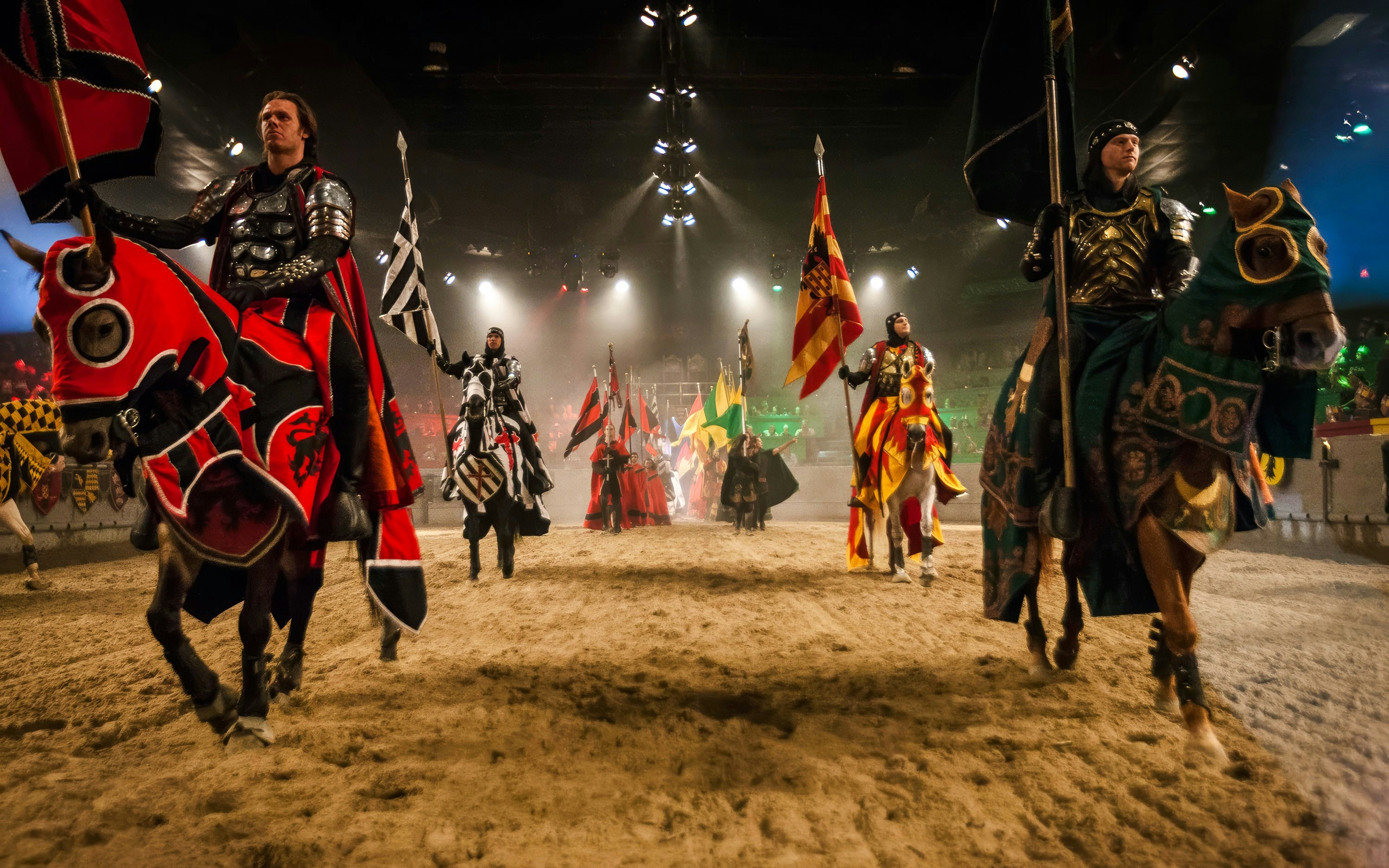 Knights on horseback in a jousting arena at Medieval Times Dinner and Show.