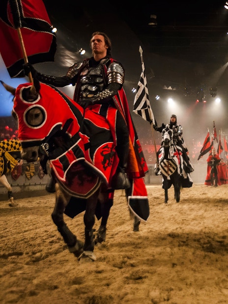 Knights on horseback in a jousting arena at Medieval Times Dinner and Show.
