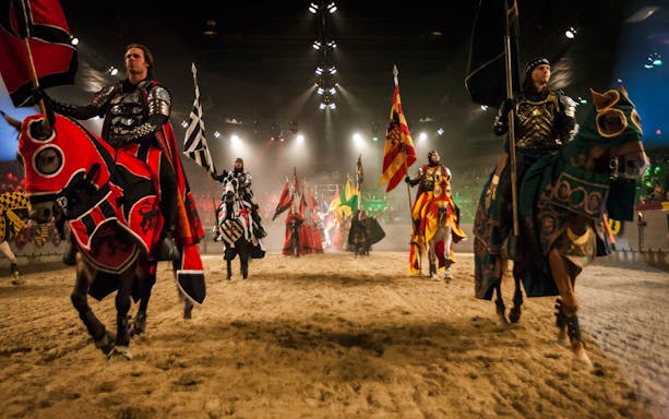 Knights on horseback in a jousting arena at Medieval Times Dinner and Show.