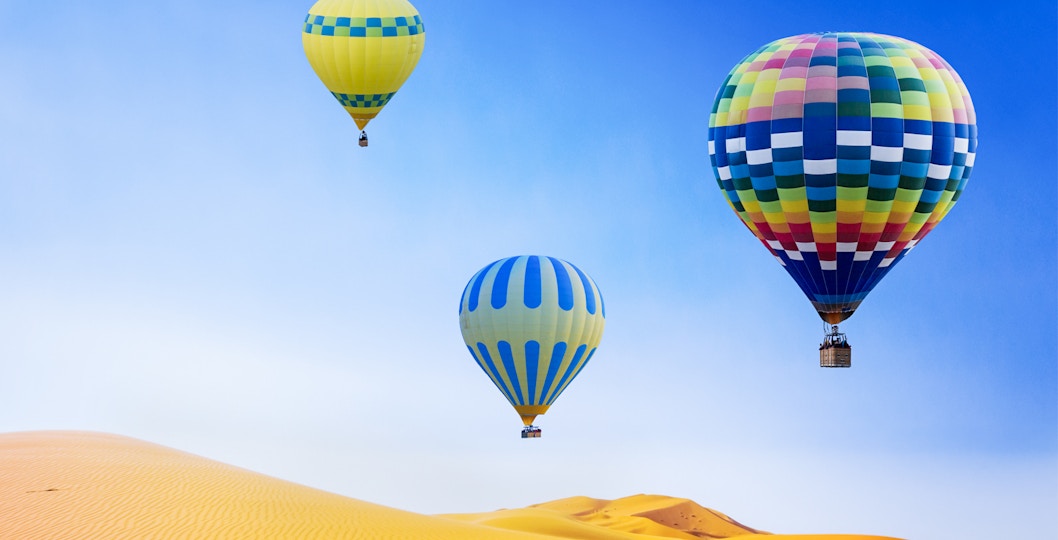 Hot air balloon ride over Dubai desert dunes.