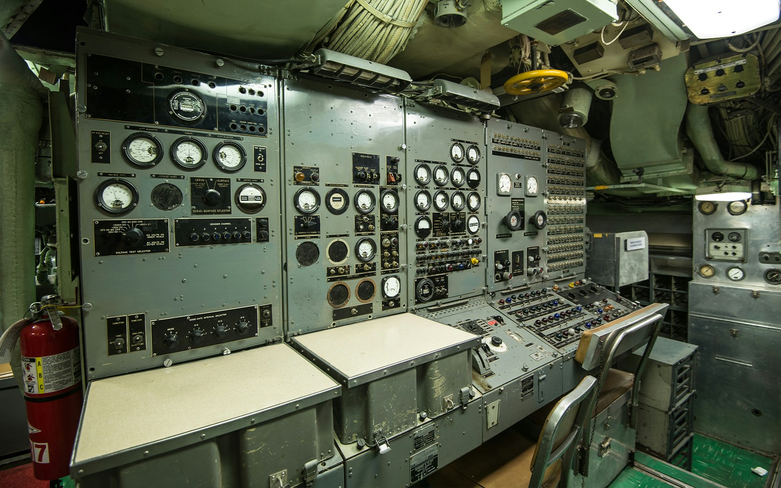 Submarine control room with dials and gauges, showcasing naval technology.