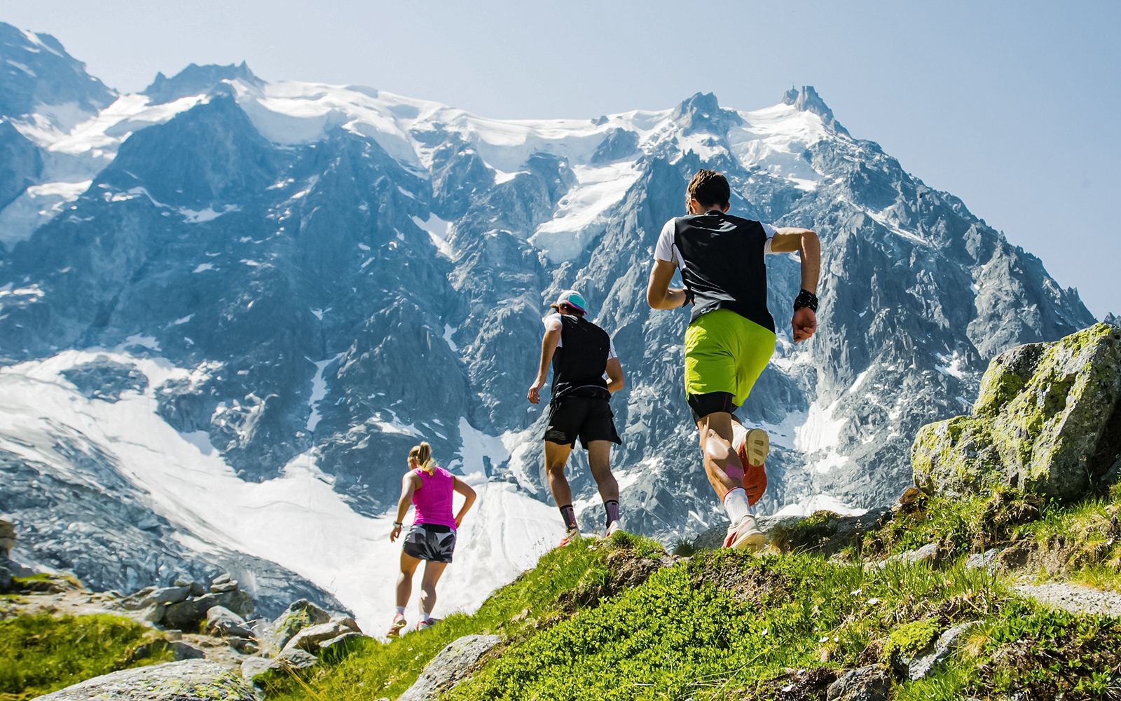 group of trail runners in mountains