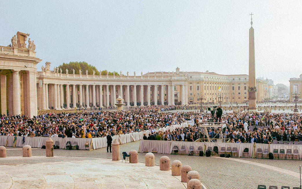 Crowd gathered at St. Peter's Square, Vatican City, for a mass event.