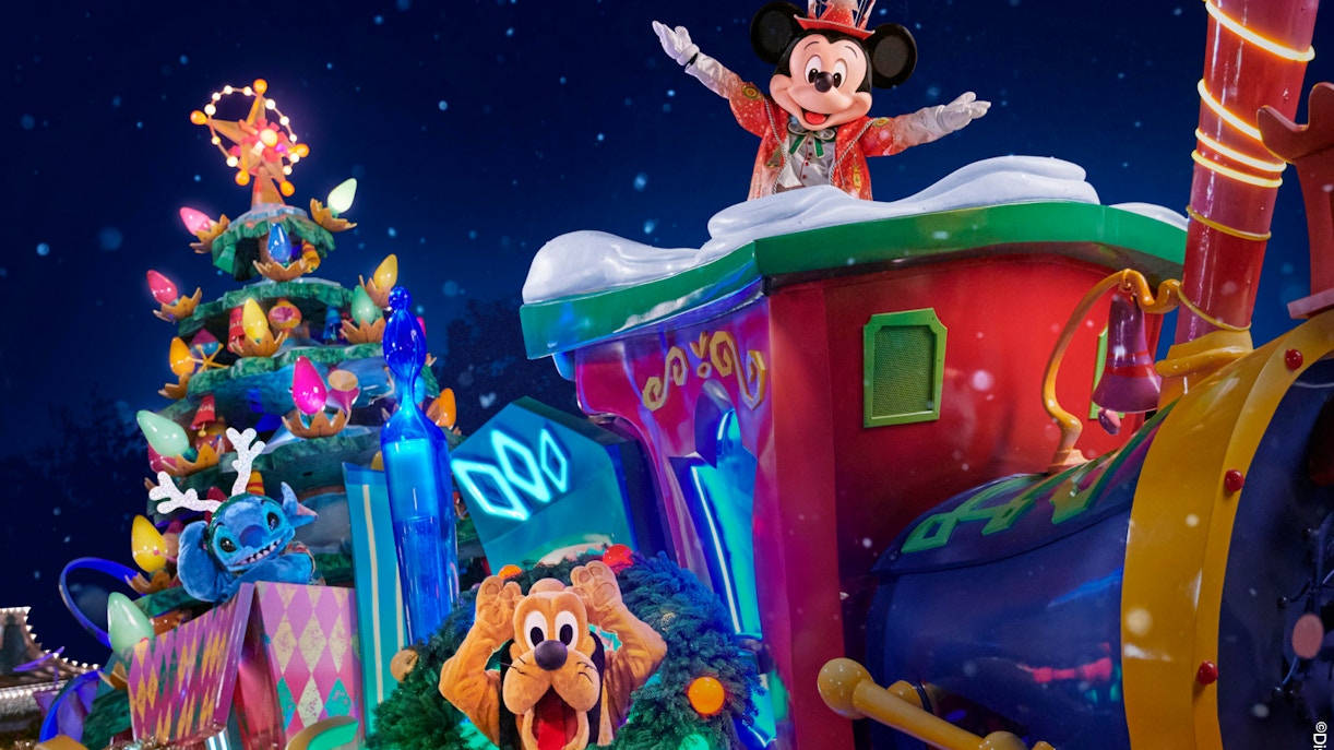 Mickey Mouse leading Christmas parade at Disneyland Paris with festive decorations