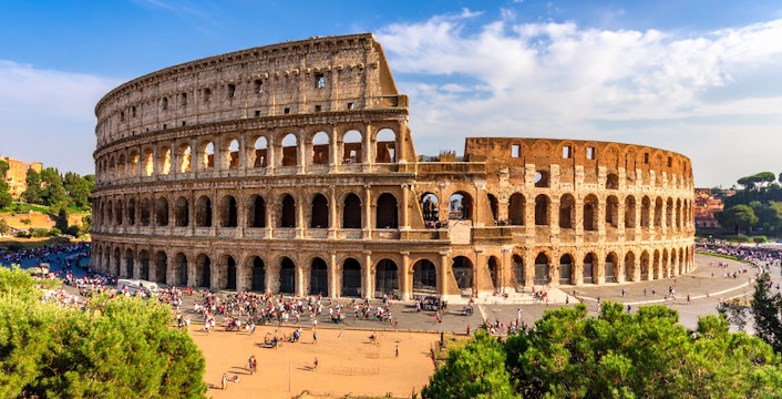 Colosseum in Rome, Italy with tourists exploring the ancient amphitheater.