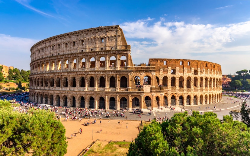 Colosseum in Rome, Italy with tourists exploring the ancient amphitheater.