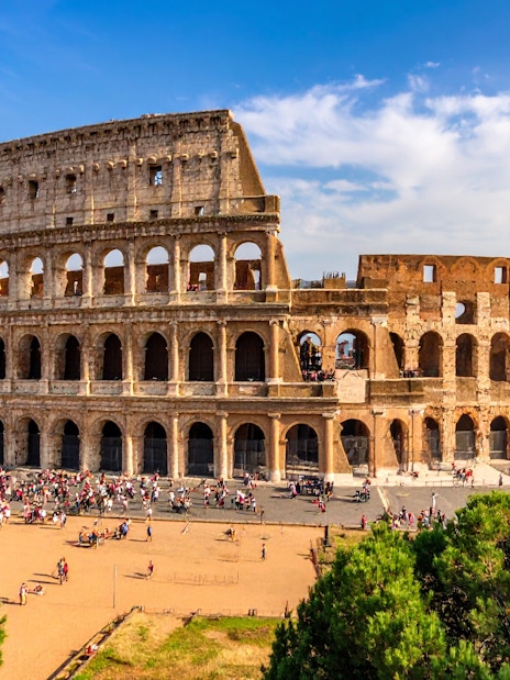 Colosseum in Rome, Italy with tourists exploring the ancient amphitheater.