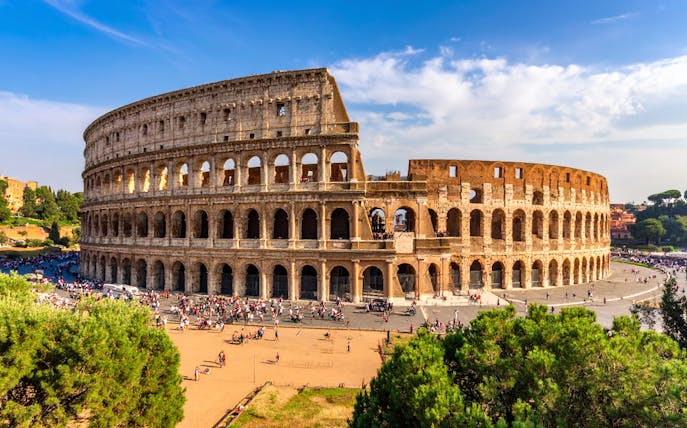 Colosseum in Rome, Italy with tourists exploring the ancient amphitheater.